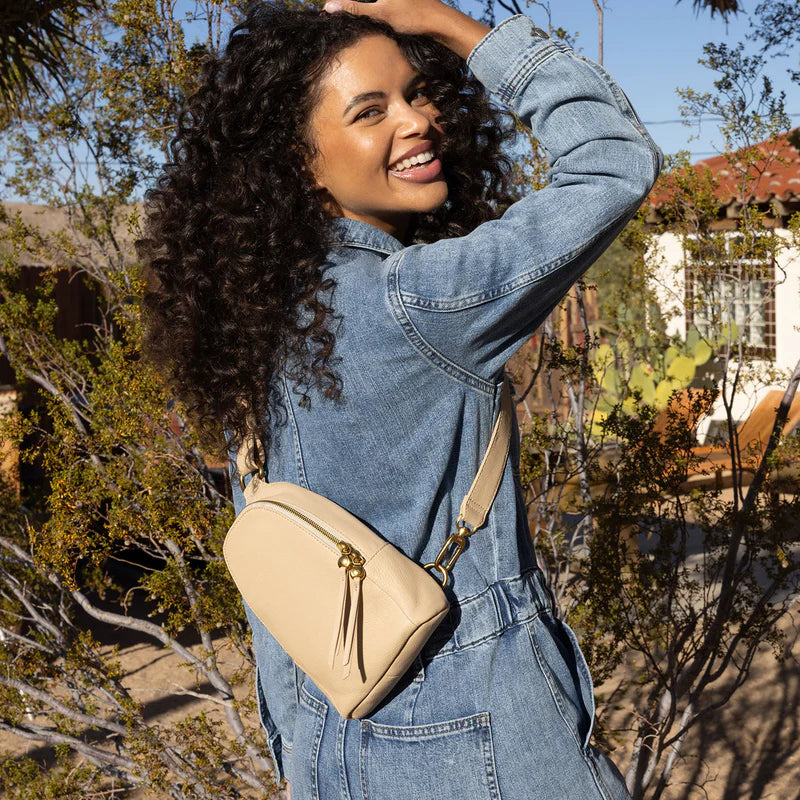 smiling person wearing denim outfit with linen Fern Sling Bag over their shoulder