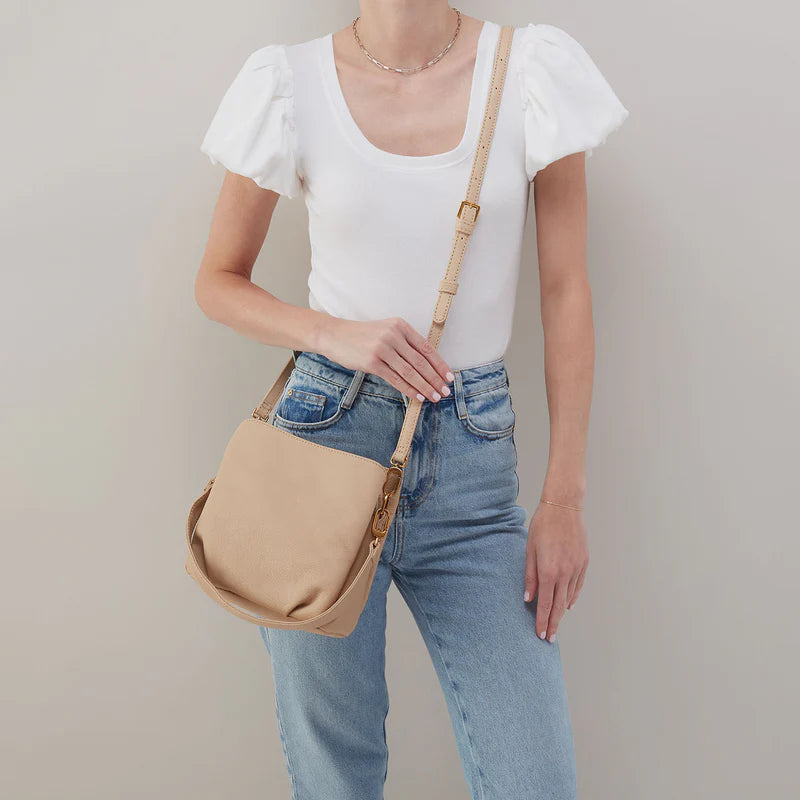 person wearing jeans and a white top with linen Starr Convertible Shoulder Bag over their shoulder