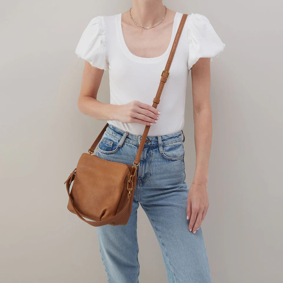 person wearing jeans and a white top with warm honey Starr Convertible Shoulder Bag worn as a crossbody