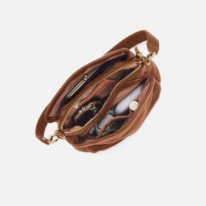 interior view of warm honey Starr Convertible Shoulder Bag showing purse content