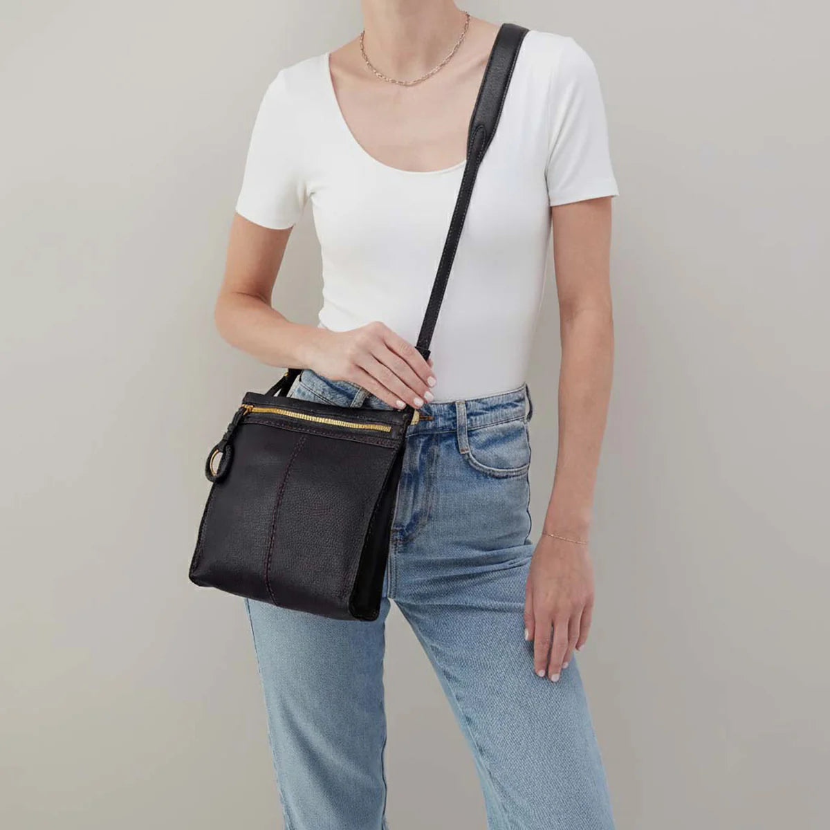 a person wearing a austin medium crossbody in black