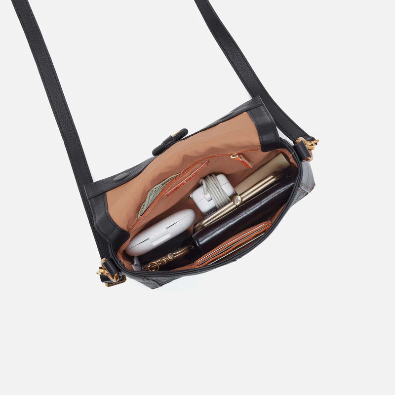Interior view of Black Austin flap crossbody showing it filled with purse content