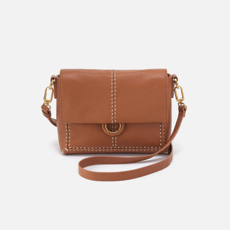 Warm honey colored Austin flap crossbody shown on a white background