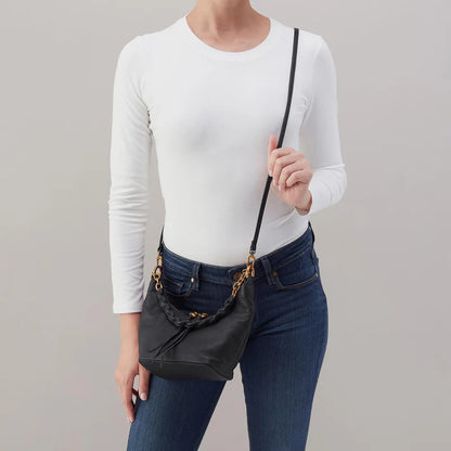 person wearing jeans and a white to p with black Astrid Small Crossbody over  their shoulder