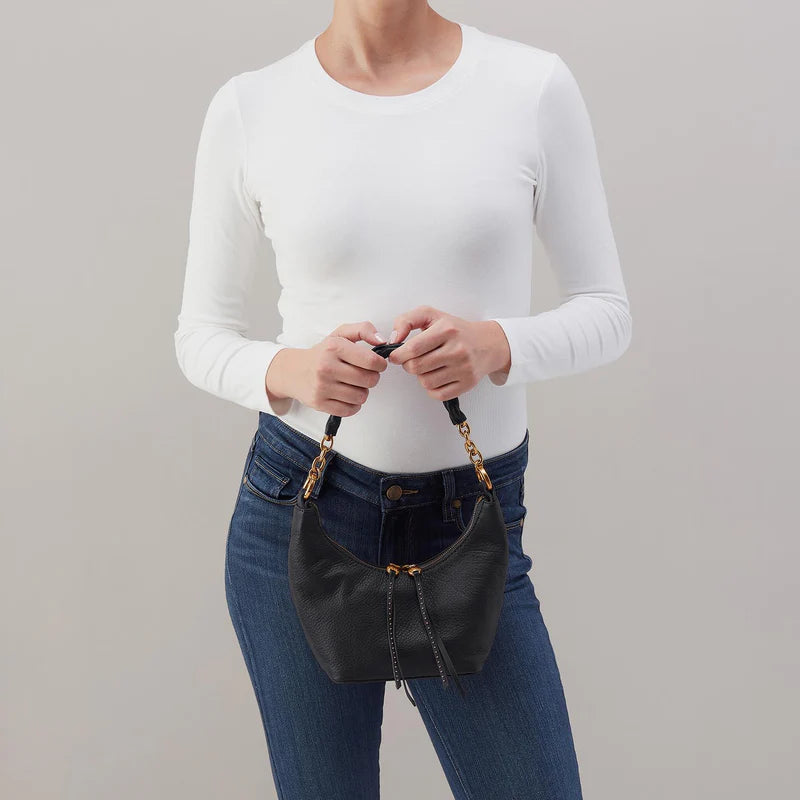 person holding black Astrid Small Crossbody