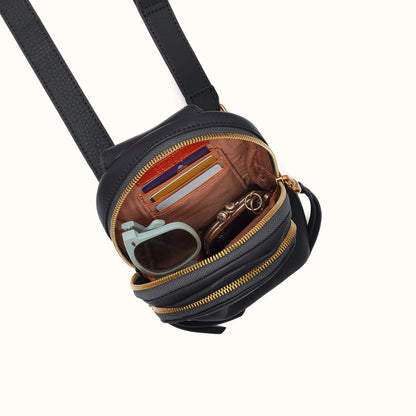 top down view of the fern sling bag open to show inside