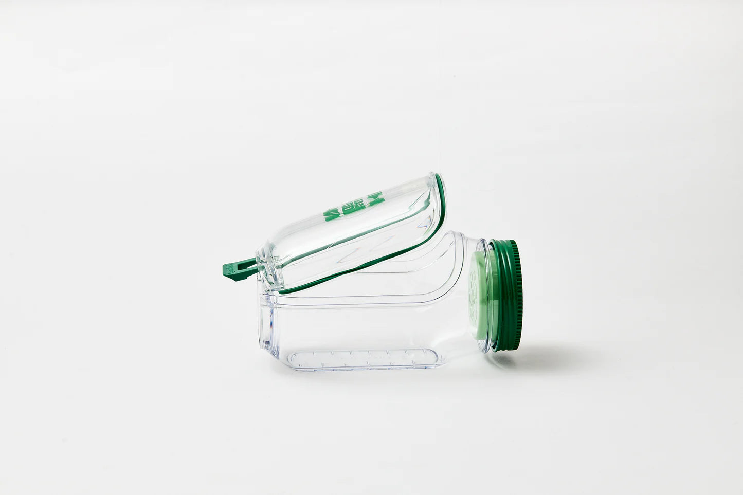 Clear plastic container with side lid open laying vertically  on a white background