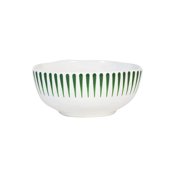 white cereal bowl with vertical green stripes near rim on a white background