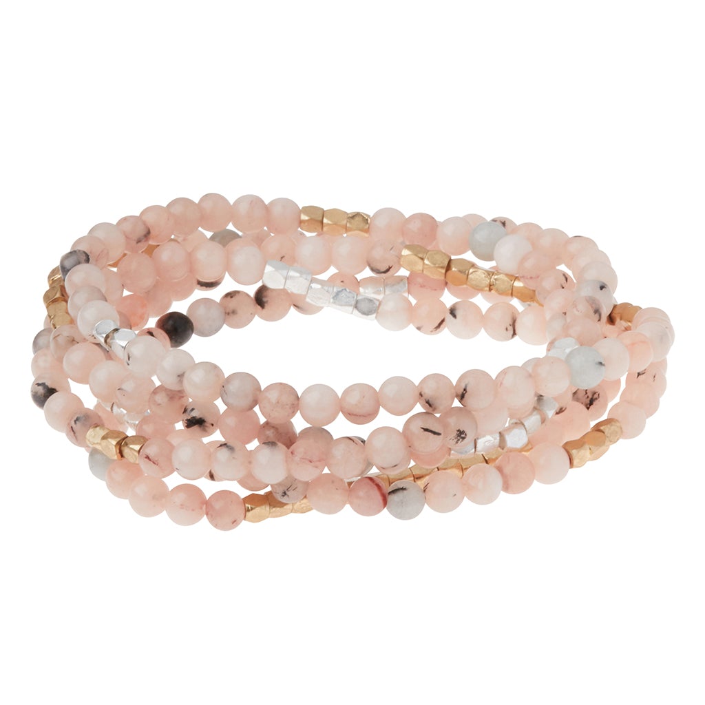4.5 millimeter pink tourmaline beads interspersed with gold and silver beads wrapped four times to form a bracelet, shown on a white background.