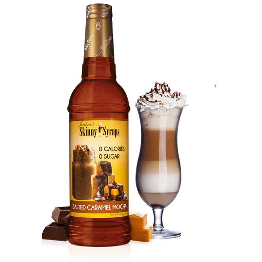 bottle of salted caramel mocha skinny syrup set next to a coffee beverage with whipped topping.