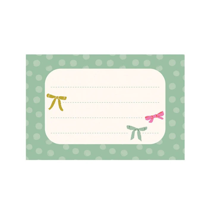 sample note sheet with green boarder and colorful bows printed on it.