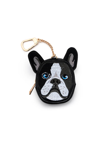 Bag charm shaped like a black and white dog's face with a gold chain and clip