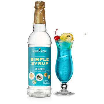 bottle of sugar free simple syrup set next to a daquiri glass filled with blue beverage and topped with lemon wedge and a cherry.