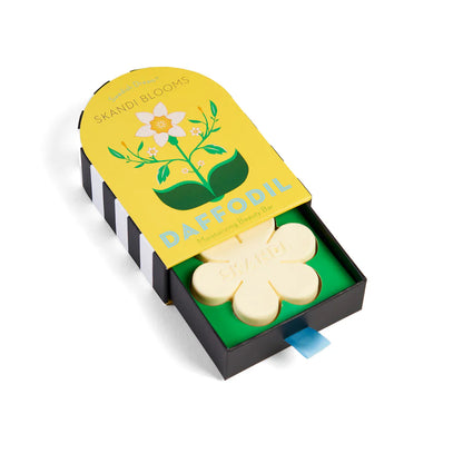 yellow box packaging slightly open showing flower shaped soap inside