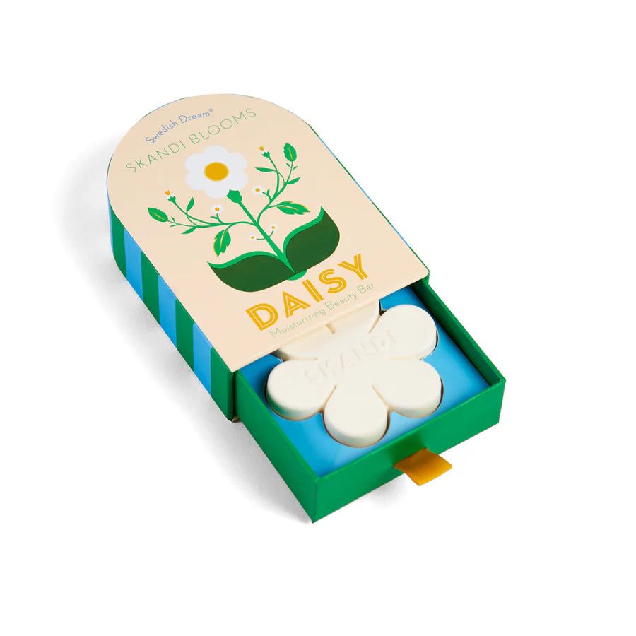 Pale yellow box with floral design slightly open showing flower shaped soap inside.