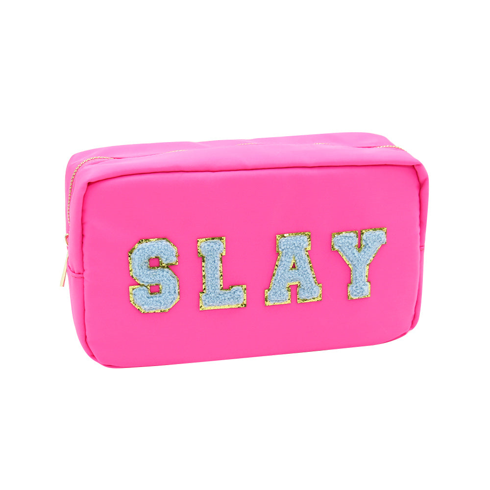 pink zipper bag with "slay" stitched on it in blue letter patches.