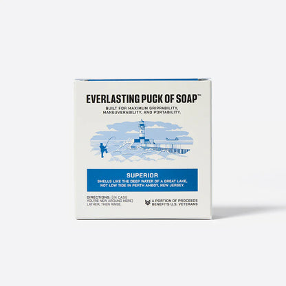 Box of 'Puck of Soap' with branding and product description on a white background

