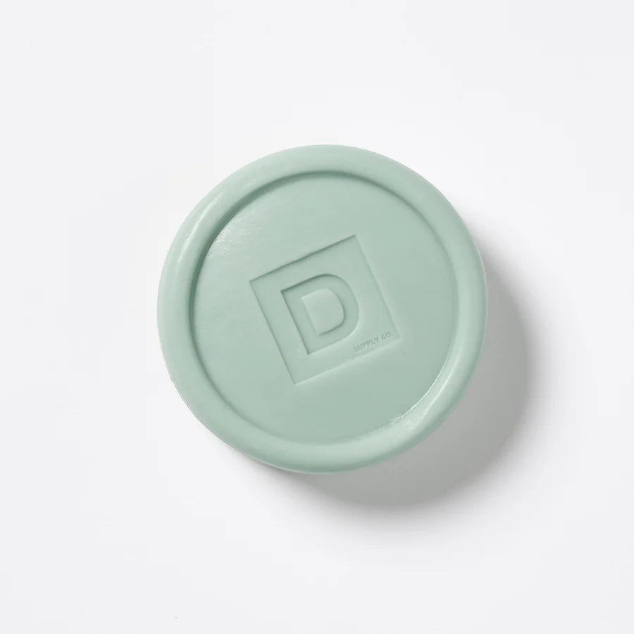 Mint green lid with a logo on a white background