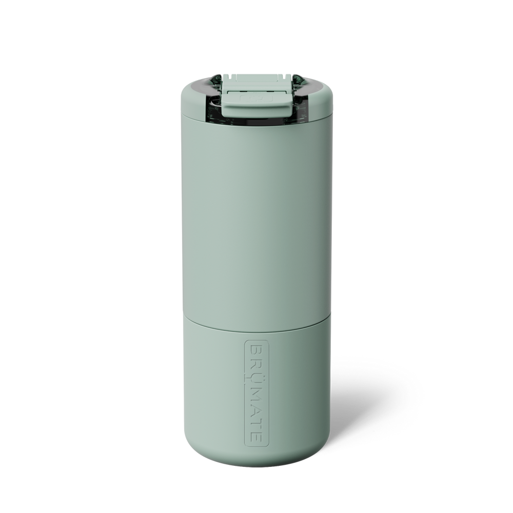 A sage green insulated travel tumbler with a flip-top lid, shown on a clean white background. 