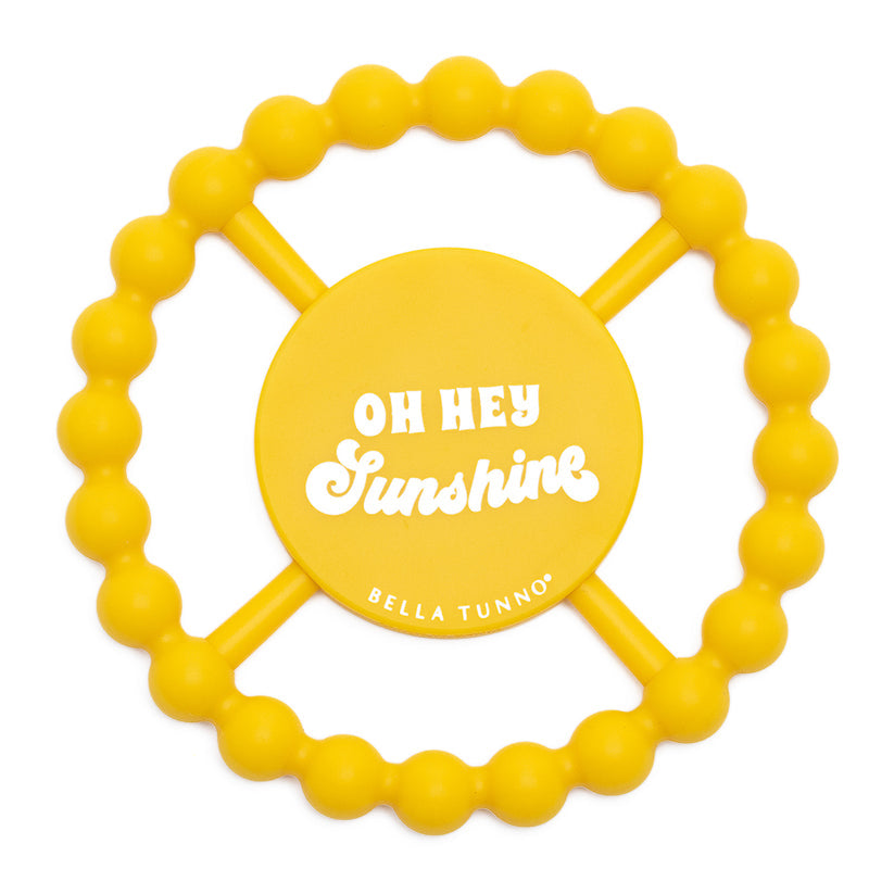 yellow silicone teether with "oh hey sunshine" printed on it.