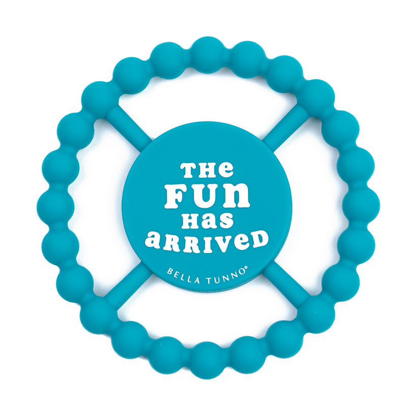 bright blue silicone teether with "the fun has arrived" printed in white in the center.