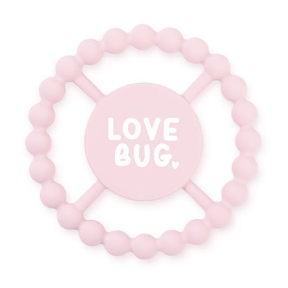 pink silicone teether with "love bug" written in the center.