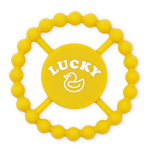 Yellow teething ring with 'LUCKY' and a duck logo shown on a white background