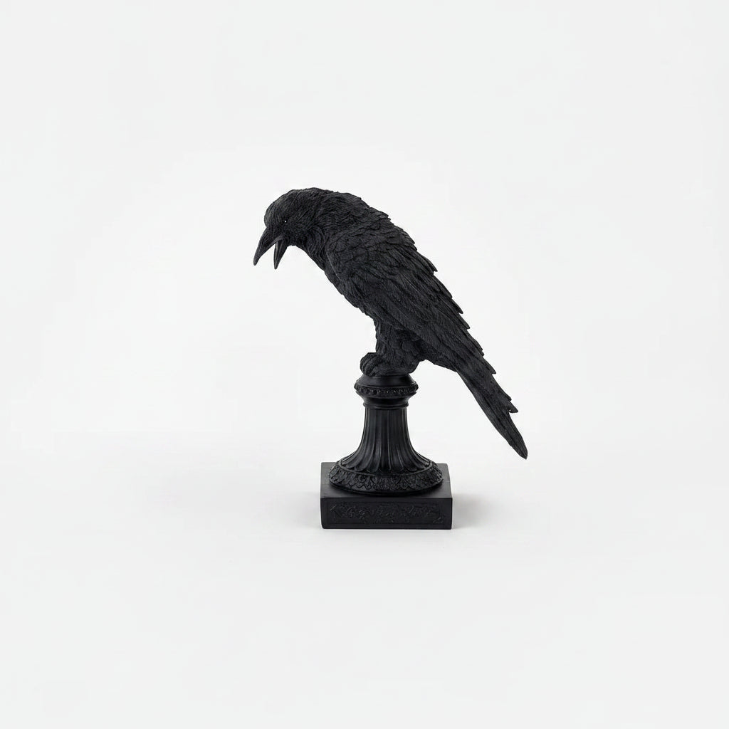 crow figurine perched on decorative pedestals with square bases, shown against a plain light background.