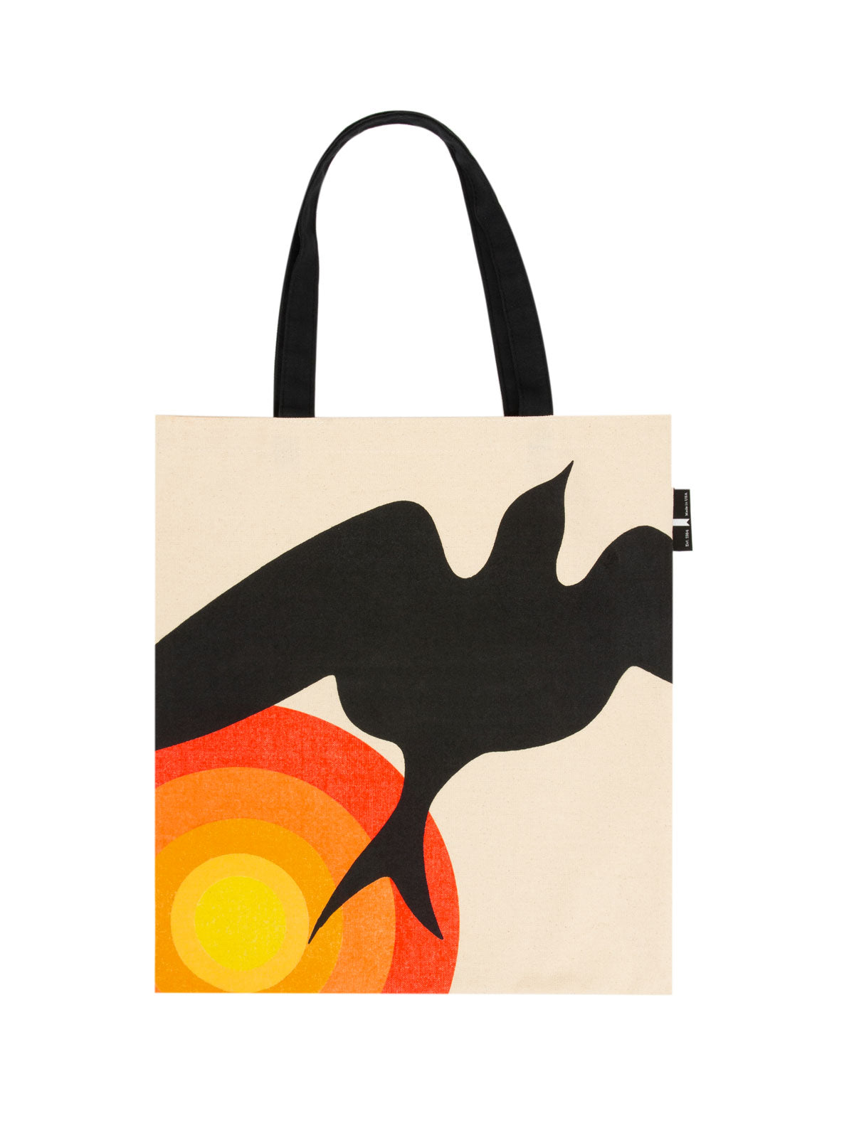 tan tote with black handle, image of a black bird flying away from an abstract sun