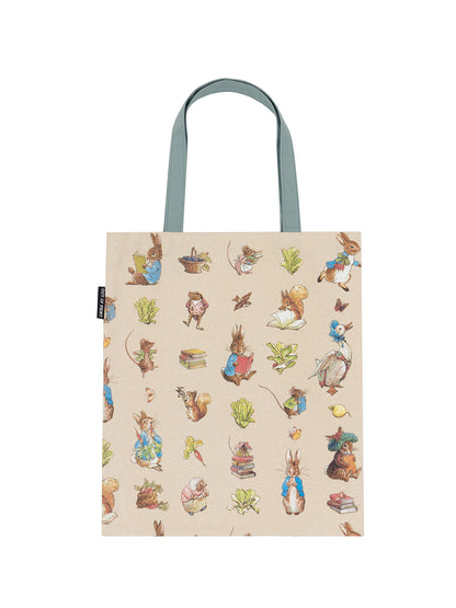 tan tote bag with slate green handles and images of Peter Rabbit characters all over it