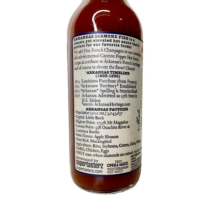 side view of label on arkansas diamond fire champagne pepper sauce bottle. call 501-327-2182 for more information