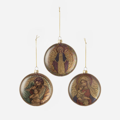Three circular religious-themed ornaments with artistic depictions of the holy family on a white background.