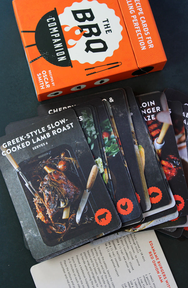 Set of BBQ recipe cards with an orange box labeled 'The BBQ Companion' on a dark surface.