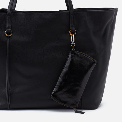 black Spark Glasses Case clp on the handle of a tote bag