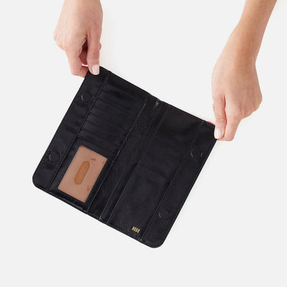 hands holding open black angle wallet