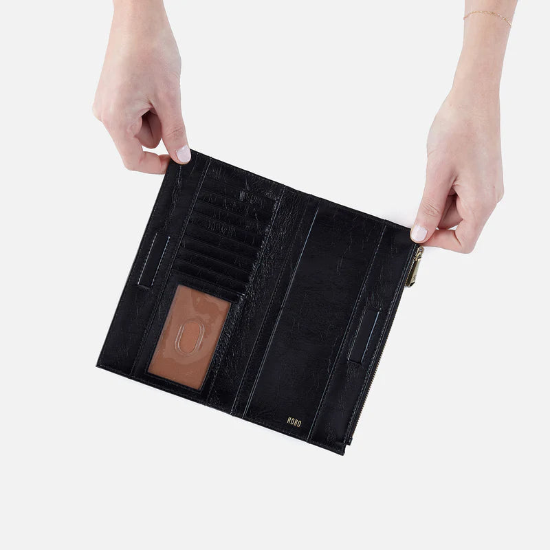 hands holding open Jill Large Bifold Wallet showing interior pockets.