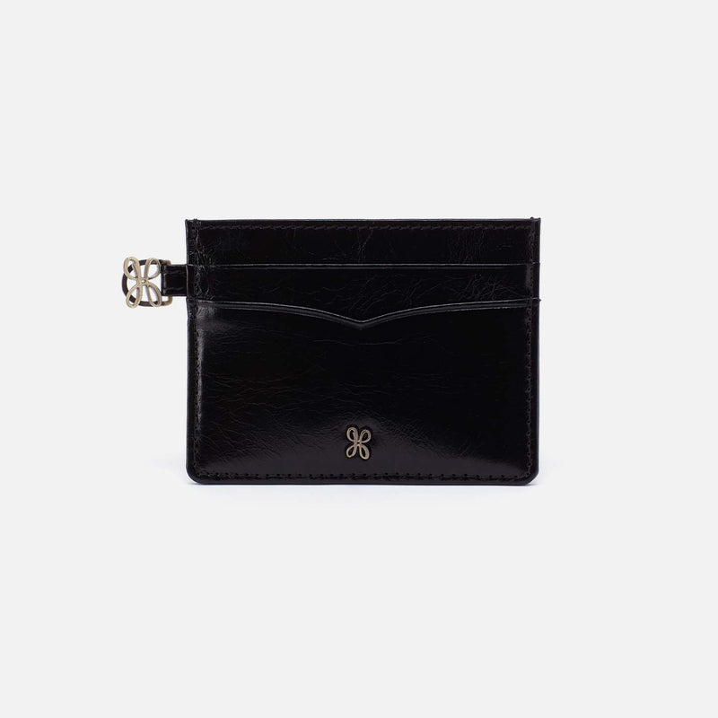 Black leather cardholder with a gold clasp on a light gray background