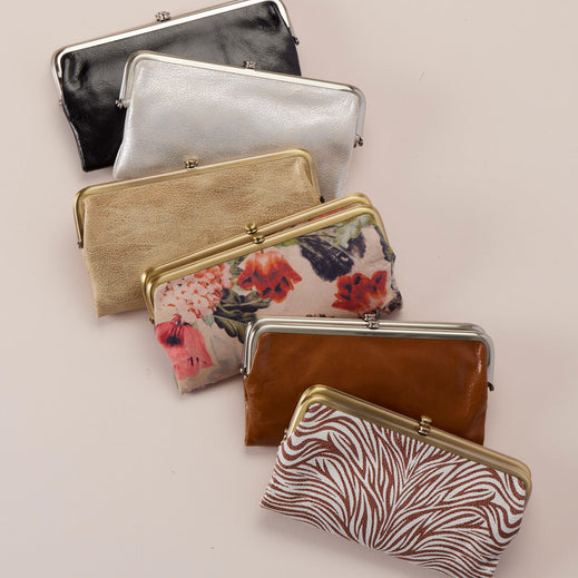 six lauren wallets laying on a cream background