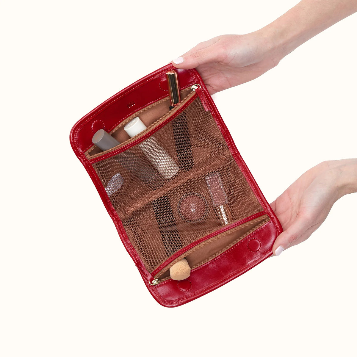 beauty cosmetic pouch in true red open with items in it
