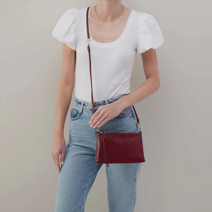 person wearing jeans and a white top carrying saddleberry Darcy Convertible Crossbody has a crossbody