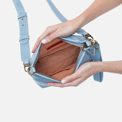 hands holding open cornflower Ashe Crossbody showing interior.