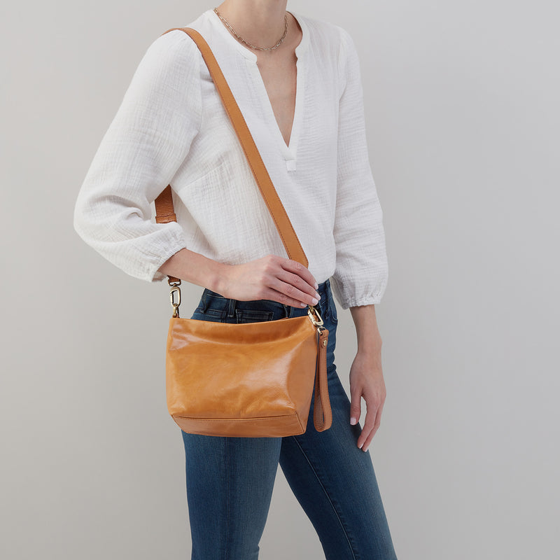 person wearing jeans and a white top with Ashe Crossbody on their shoulder.