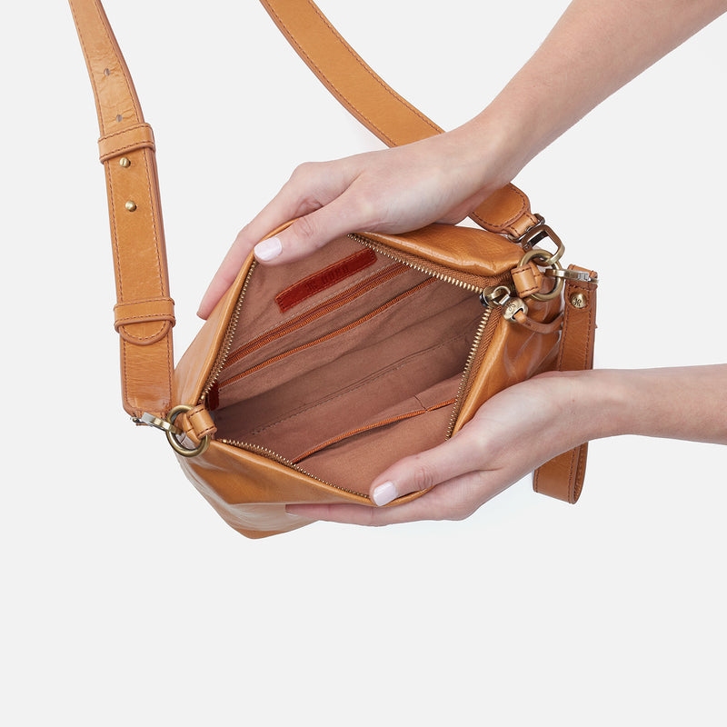 hands holding open Ashe Crossbody showing interior.