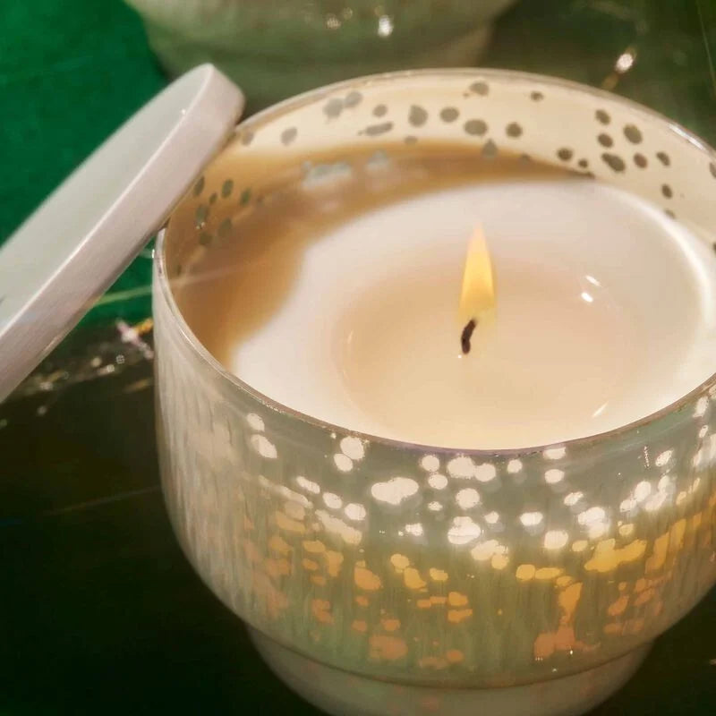 close-up of lit volcano candle in inverted jar.