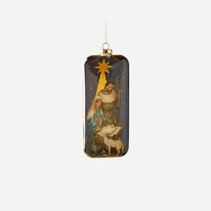 holy family ornament with image of baby jesus in manger next to a lamb, mary and joseph standing near, and a star above