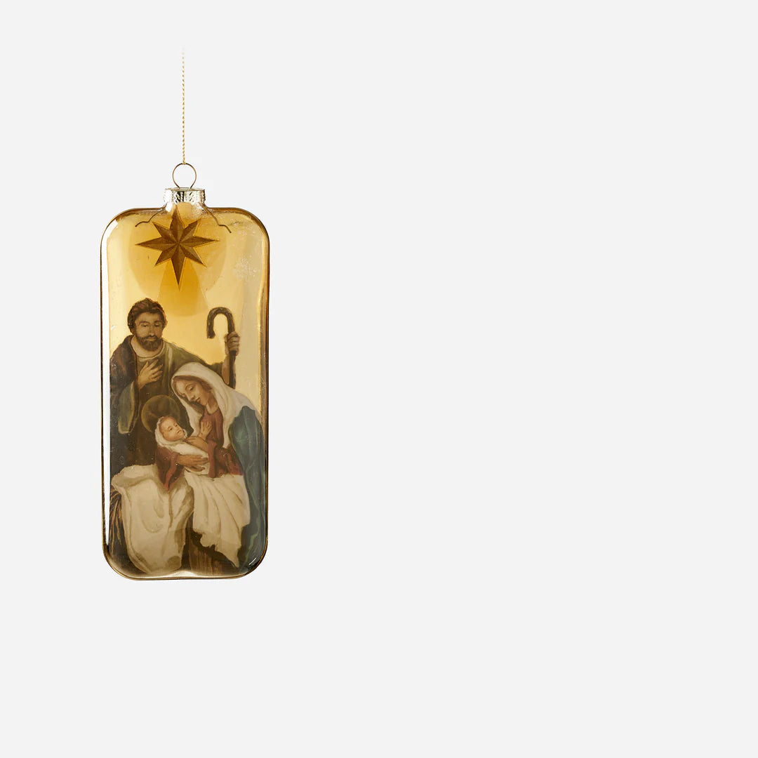 holy family ornament with image of mary holding baby jesus, joseph standing near, and a star above