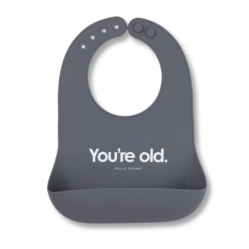 grey silicone bib with "you're old" printed in white on it