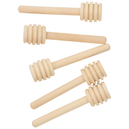 Set of five wooden honey dipper sticks on a white background