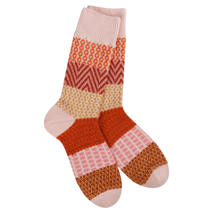 red, orange, pink, yellow patterned socks on white background