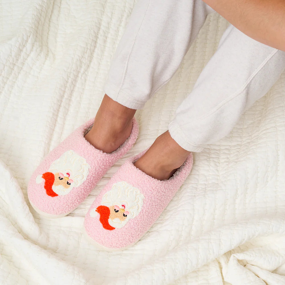 feet wearing pink Santa slippers.